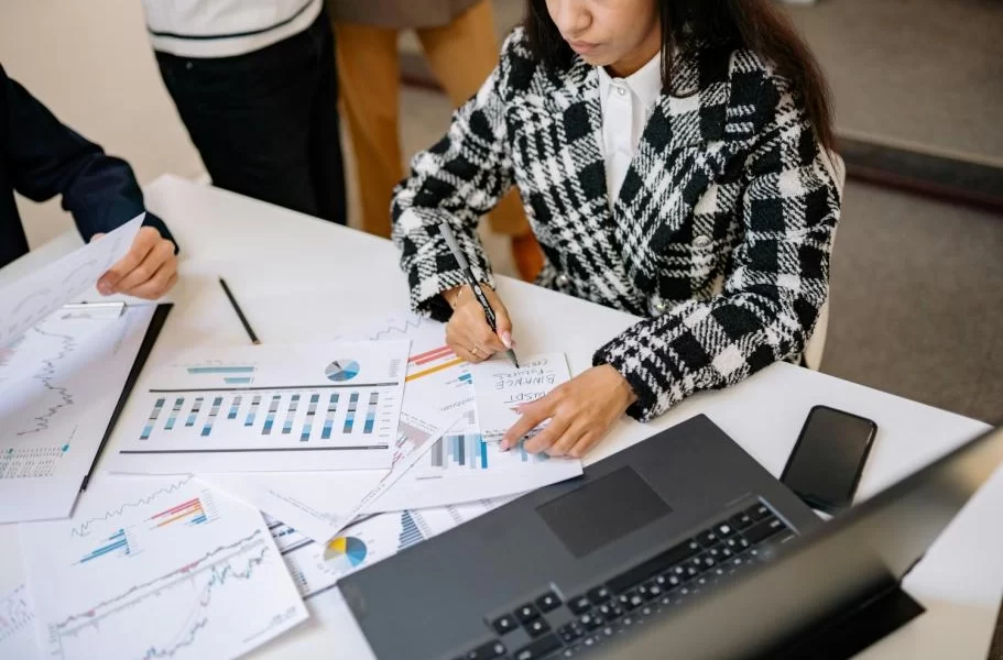 Professionals reviewing financial documents and charts during a cross-border tax planning discussion involving U.S. and Canadian reporting.